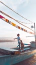 two little boys playing in a boat on the beach Royalty Free Stock Photo