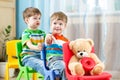 Two little boys playing role game in daycare