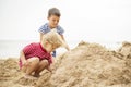 Two little boys playing on sandy beach. Cute kids building sandcastles on beach Royalty Free Stock Photo