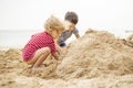 Two little boys playing on sandy beach. Cute kids building sandcastles on beach Royalty Free Stock Photo