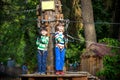 Two little boys playing together and having fun. Lifestyle family moment of siblings on playground. Kids friends play on rope park