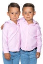 Two little boys in shirts and jeans.