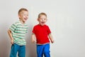 Two little boys siblings playing together on table