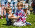 Two little boys with their dog in the park at a dog show