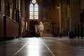 Two little boys are walking out of an empty Catholic church