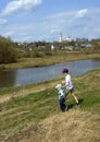 Two little boys walking on the river bank on horizon line background. Brothers holding hands. Royalty Free Stock Photo