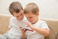 Two boys playing games on smartphone at home Royalty Free Stock Photo