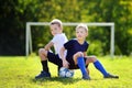 Two little brothers having fun playing a soccer game
