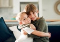 A big brother means youre protected. two little brothers hugging each other on the couch at home. Royalty Free Stock Photo