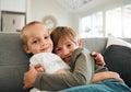 I have a best friend for life. two little brothers hugging each other on the couch at home. Royalty Free Stock Photo