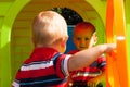 Two little brothers in playhouse