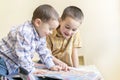 Two little brothers read a children`s book. Children`s friendship, fun education Royalty Free Stock Photo