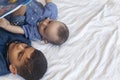 Two little brothers reading a book. Infant kids lying on the bed and read the tale before sleeping. Reading a short story for Kids Royalty Free Stock Photo