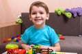 Two little caucasian friends playing with lots of colorful plastic blocks indoor. Active kid boys, siblings having fun building an Royalty Free Stock Photo