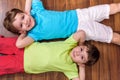 Two little caucasian friends playing with lots of colorful plastic blocks indoor. Active kid boys, siblings having fun building an Royalty Free Stock Photo