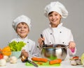 Two little chefs cook and smile Royalty Free Stock Photo