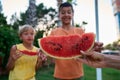 Two little children, boy brothers, eating watermelon in the park, summertime Royalty Free Stock Photo