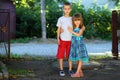 Two little children brother and sister together. Girl in dress h Royalty Free Stock Photo