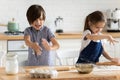 Siblings playing with flour having fun at home enjoy cooking