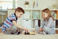 Two little children playing chess at home Royalty Free Stock Photo