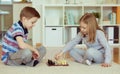 Two little children playing chess at home Royalty Free Stock Photo