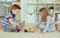 Two little children playing chess at home Royalty Free Stock Photo