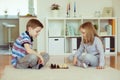 Two little children playing chess at home Royalty Free Stock Photo