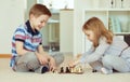 Two little children playing chess at home Royalty Free Stock Photo