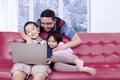 Two children watch a movie with their father Royalty Free Stock Photo