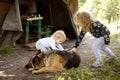 Two little girls tent camp mountains petting   dog Royalty Free Stock Photo