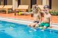 Two little cute boy is catching a toy fish in the pool Royalty Free Stock Photo