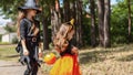 Two little cute girl in witch costume holding jack-o-lantern pumpkin bucket. Kids trick or treating in Halloween holiday Royalty Free Stock Photo