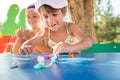 Two little cute girls playing dolls outdoors Royalty Free Stock Photo