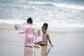 Two little cute kid girl  having fun on sandy summer with blue sea, happy childhood friends playing on tropical beach with Royalty Free Stock Photo