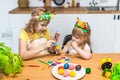 Two little cute girls painting on Easter eggs Royalty Free Stock Photo
