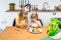 Two little cute girls painting on Easter eggs at home Royalty Free Stock Photo