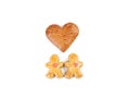 Two little fallen in love gingerbread figure and in between two little figure is one gingerbread heart.