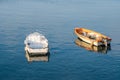 Two little fishing boats floating on the Mediterranean sea shore. Italy Royalty Free Stock Photo