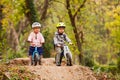 Two little friends sitting on balancing bikes Royalty Free Stock Photo