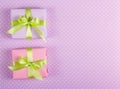 Two Little Gift Boxes With Green Ribbons On A Gentle Background With Polka Dots.