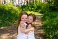 Two little girl girl friends hugging in the forest Royalty Free Stock Photo