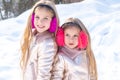 Two little Girl playing with snow in park. Winter kids portrait. Two adorable young girls having fun together in Royalty Free Stock Photo