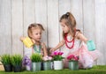 Two little girl watering flowers Royalty Free Stock Photo