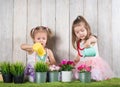 Two little girl watering flowers Royalty Free Stock Photo