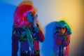 Two little girls blowing kiss wearing a colorful wig and heart-shaped sunglasses Royalty Free Stock Photo