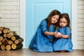 Two little girls in blue dresses with a white bird