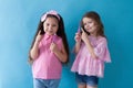 Two little girls brush their teeth with a toothbrush Royalty Free Stock Photo