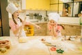 Two little girls chefs are laughing on the kitchen Royalty Free Stock Photo