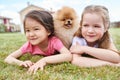 Two Little Girls with Cute Puppy Outdoors Royalty Free Stock Photo