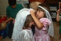 Two little girls dressing up in wedding outfits